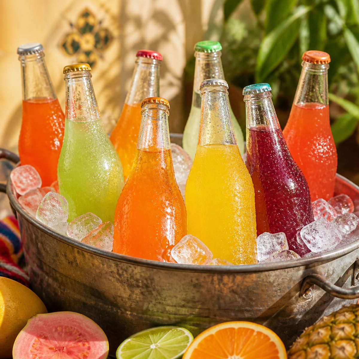 Bottles of Mexican fruit sodas chilling in a tub of ice